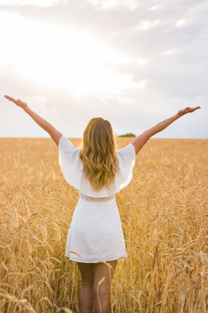 woman in field praising God