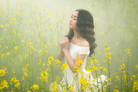 woman praying in a field of flowers