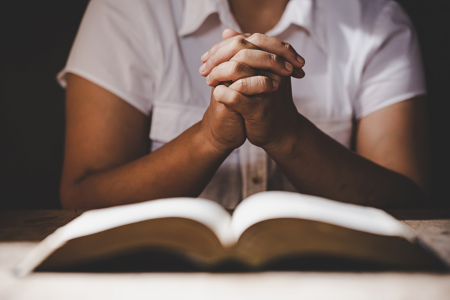 woman praying and reading bible verses for when you feel alone