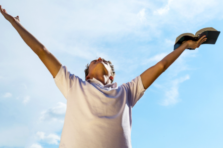 man with hands lifted to heaven