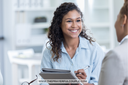 young woman smiling with pen and clipboard