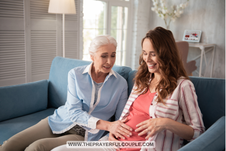 mother touching tummy of pregnant daughter