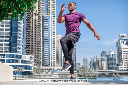 energetic man jogging with city skyline in background