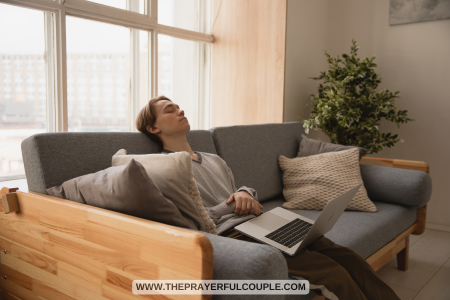 man with laptop napping on couch