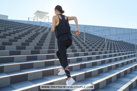 motivated woman running up flight of stairs